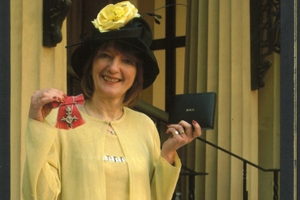 Dot holding her MBE Medal
